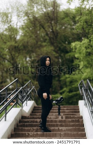 A woman warms up on the stairs and shoots a video blog on camera