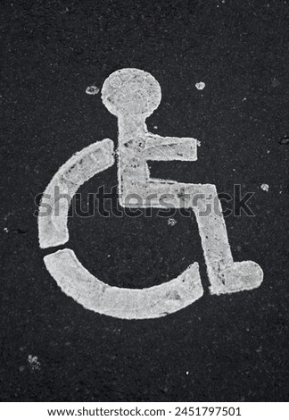 Exterior close up photo view of a signssignage logo symbol of a disable handicapped wheel chair people painted on the ground in a city town pavement road armchair 