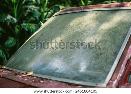 "Discover the beauty in neglect with our vintage car window: dust-covered, time-worn, and full of stories. Perfect for your creative projects! #VintageCharm" Royalty-Free Stock Photo #2451804105