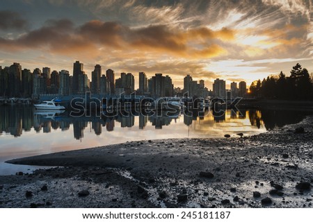 Vancouver Skyline. The beautiful Vancouver skyline taken from Stanley Park during sunset. The city marina can be seen in the foreground.