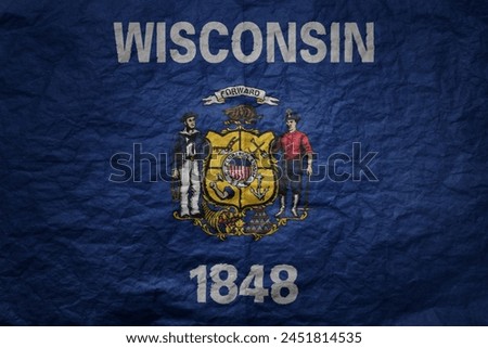 colorful big national flag of wisconsin state on a grunge old paper texture background