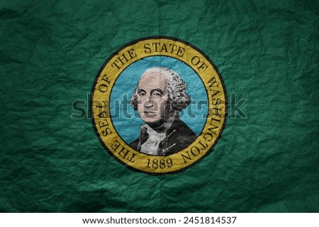 colorful big national flag of washington state on a grunge old paper texture background