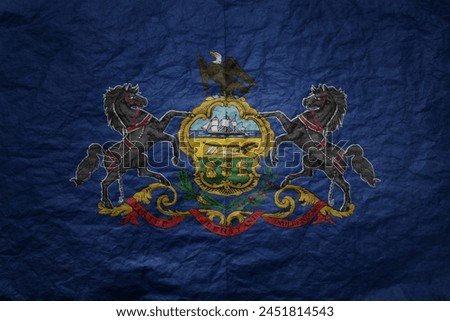 colorful big national flag of pennsylvania state on a grunge old paper texture background