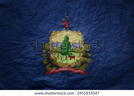colorful big national flag of vermont state on a grunge old paper texture background