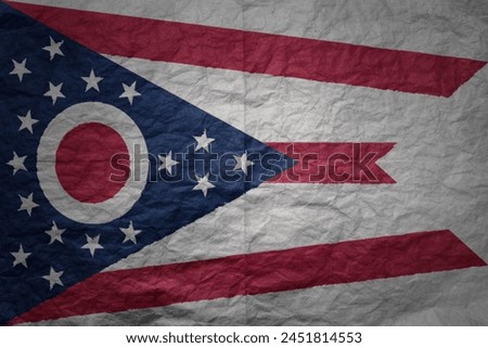 colorful big national flag of ohio state on a grunge old paper texture background