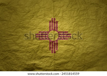 colorful big national flag of new mexico state on a grunge old paper texture background
