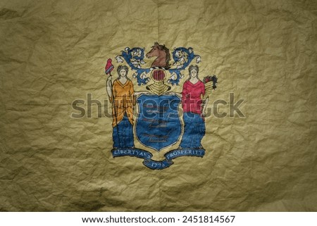 colorful big national flag of new jersey state on a grunge old paper texture background