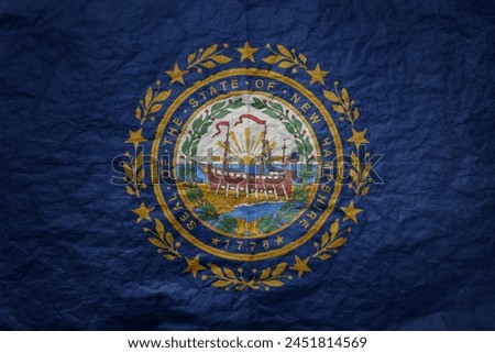 colorful big national flag of new hampshire state on a grunge old paper texture background
