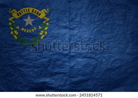 colorful big national flag of nevada state on a grunge old paper texture background