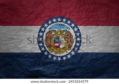 colorful big national flag of missouri state on a grunge old paper texture background