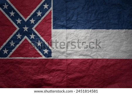 colorful big national flag of mississippi state on a grunge old paper texture background