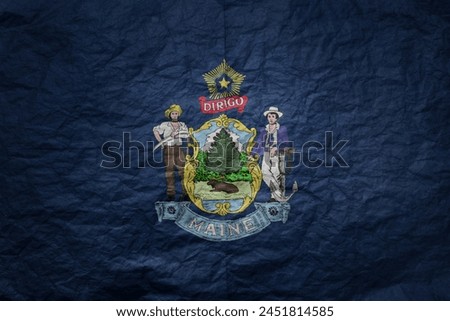 colorful big national flag of maine state on a grunge old paper texture background