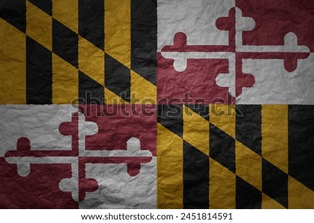 colorful big national flag of maryland state on a grunge old paper texture background