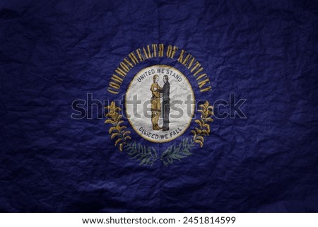 colorful big national flag of kentucky state on a grunge old paper texture background