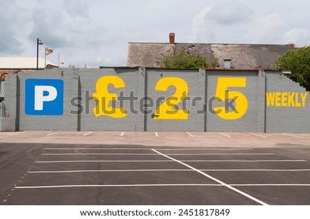 Wall painted with an advertisement for car parking for £25 weekly.