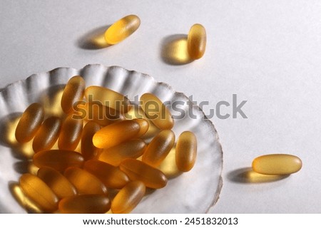 everyday supplements, wellness, multivitamin, healthy lifestyle concept. Vitamins Omega 3 on shell on white background. copy space. Royalty-Free Stock Photo #2451832013