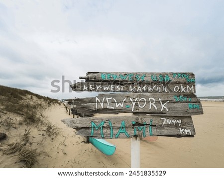 Wooden signs on the sandy sea beach