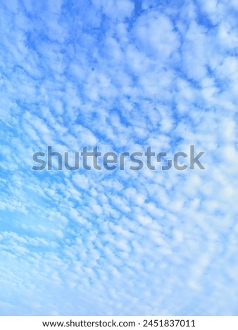blue sky with clouds like wool  Royalty-Free Stock Photo #2451837011