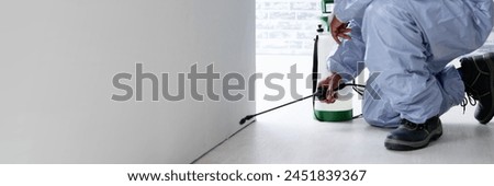 Man in office pest control spraying exterminator cockroach