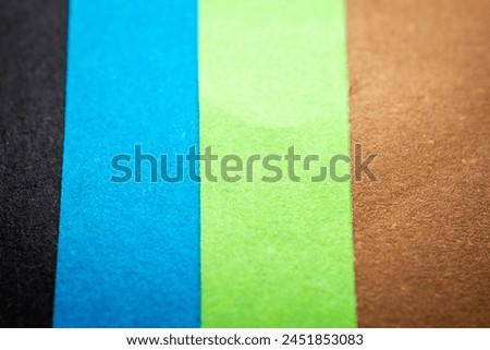 Extreme macro of multicolor background from different colors papers. Abstract colorful vibrant paper textures. Selective focus, shallow depth of field.