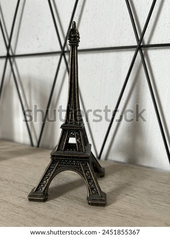 Photo of the statuette of the Eiffel Tower. element of the interior. stylish decoration for home.