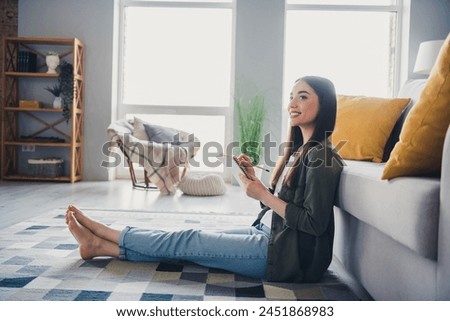 Full size photo of pretty young lady sit floor hold notepad think wear green shirt weekend modern apartment indoors