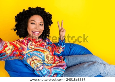 Portrait of nice young woman make selfie show v-sign wear pullover isolated on yellow color background