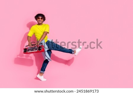 Photo of funny carefree cheerful man wear stylish yellow clothes enjoy street dance empty space isolated on pink color background
