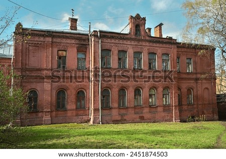 AN OLD RED BRICK HOUSE FROM THE BEGINNING OF THE TWENTIETH CENTURY IN MOSCOW. THE BUILDING OF THE CLOTH MANUFACTORY, THE DIRECTOR'S HOUSE. ARCHITECT D.P.SUKHOV Royalty-Free Stock Photo #2451874503