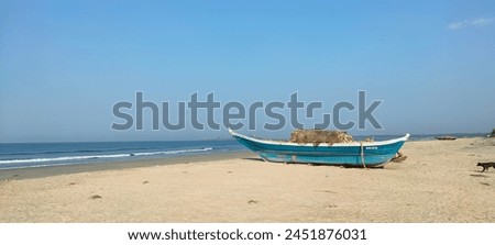A beautiful view of the fishing boat under the blue sky on the beach sand