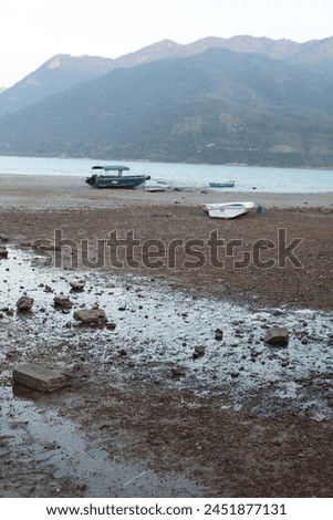 Exterior photo landscape view of s scenic panoram scene of Sai Kung sea ocean cost wild beach with trees hills mountains with stranded fishing wood boat on he sand HK Hong Kong