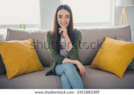 Photo of pretty young woman sit couch think wear shirt modern interior apartment indoors