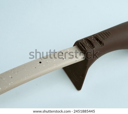 Brown colored spatula cooking kitchenware with melted silicone handle from high hot temperature. Object photography isolated on white background.