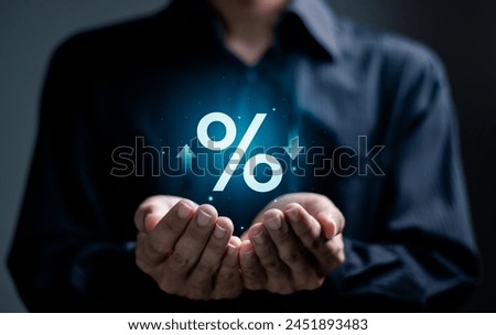 Financial interest rate and mortgage rate concept, interest rates stocks, Finance ratings. Businessman hold percentage icon with up and down arrow for graph indicators.