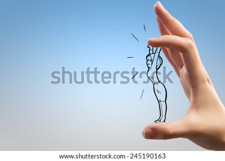Human hand and funny caricature of businesswoman