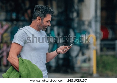 young man on the street with mobile phone