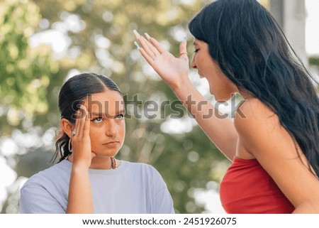 friends arguing or fighting outdoors Royalty-Free Stock Photo #2451926075