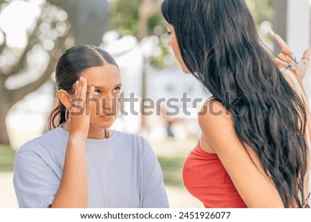 friends arguing or fighting outdoors Royalty-Free Stock Photo #2451926077