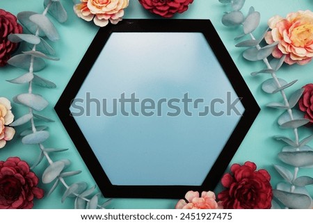Blue Hexagon background and black border decorate with flowers on blue background