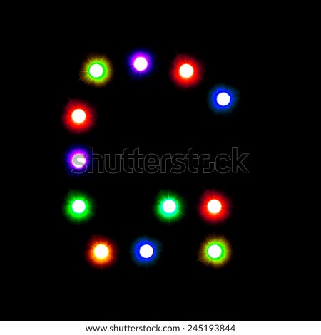 defocused colorful letter G made of blurred circular bokeh on black background 