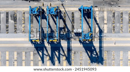 RTG cranes are lifting containers at the port.

 Royalty-Free Stock Photo #2451945093