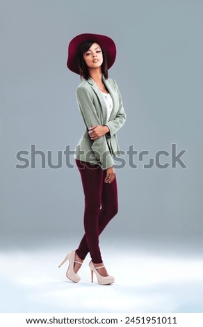 Woman. fashion and portrait with retro style and chic clothes in a studio with confidence. Trendy, classy and young designer student from Houston with smart casual outfit and grey background