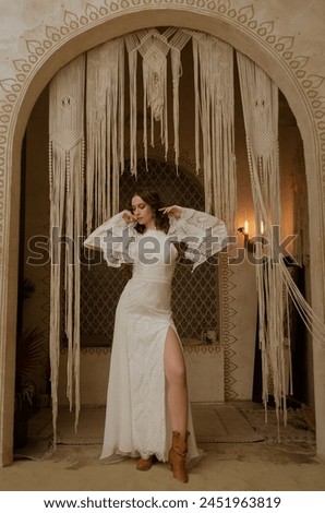 Young beautiful girl posing in a long boho style wedding dress