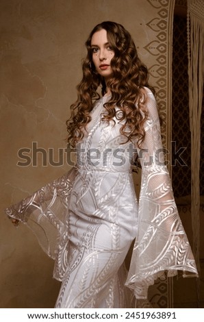 Young beautiful girl posing in a long boho style wedding dress