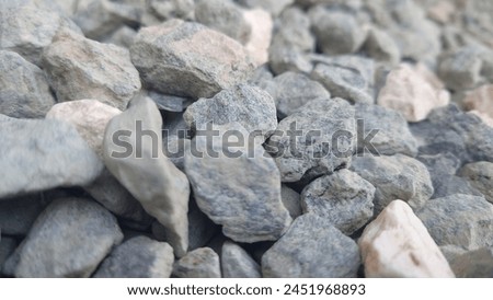 Close up of gray rocks on the ground, high resolution photography, professional color grading, soft shadows, no contrast, clean sharp focus digital photography. 