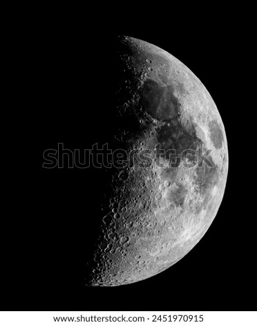 A captivating black and white photo captures the beauty of the crescent Moon shining in the midnight sky, a stunning astronomical object in the vast universe Royalty-Free Stock Photo #2451970915