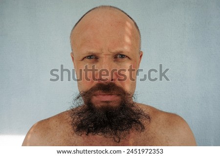 Men's beard. The guy's face is large. Brutal macho. Mustache and beard. Barber. Lumberjack. Portrait of a handsome man with a beard                                Royalty-Free Stock Photo #2451972353