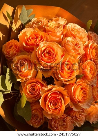 A beautiful orange roses bouquet, birthday gift in a sunny day