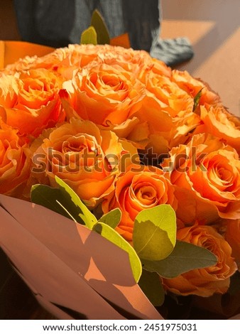 A beautiful orange roses bouquet, birthday gift in a sunny day