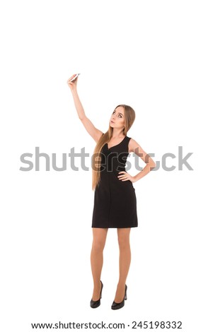 girl in a black short dress on a white background. girl photographed herself